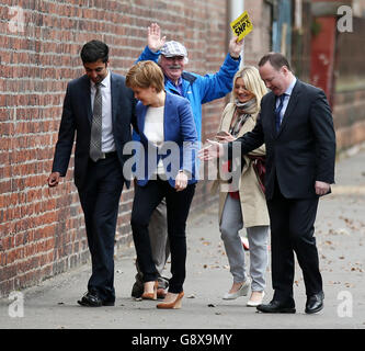 SNP Leader and First Minister Nicola Sturgeon (second left) with local candidates Humza Yousaf (left), Bill Kidd (right) and an SNP supporter (centre) at the gates of BAE Systems at Govan shipyard in Glasgow, where she met with Trade Union representatives whilst on the Scottish election campaign trail. Stock Photo