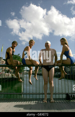 Swimmers pose before leaping from the Millennium Bridge into the River Liffey in Dublin, ahead of the 85th Liffey Swim, which will see hundreds of competitors swim the 2.4 kilometres from Watling Street Bridge to the Custom House. Stock Photo