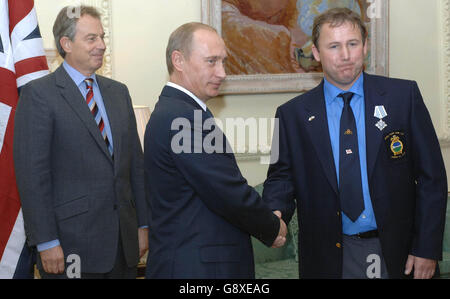 Peter Nuttall receives the 'Order For Maritime Services' from Russian President Vladimir Putin as British Prime Minsiter Tony Blair looks on at Downing Street, Wednesday October 5, 2005, for his part in freeing the Russian submersible, AS28 Priz in August. See PA Story DEFENCE Putin. PRESS ASSOCIATION Photo. Photo credit should read: Stefan Rousseau/PA/WPA Rota Stock Photo