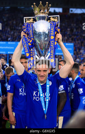 Leicester City's Andy King with the trophy as the team celebrate winning the Barclays Premier League, after the match at the King Power Stadium, Leicester. Stock Photo