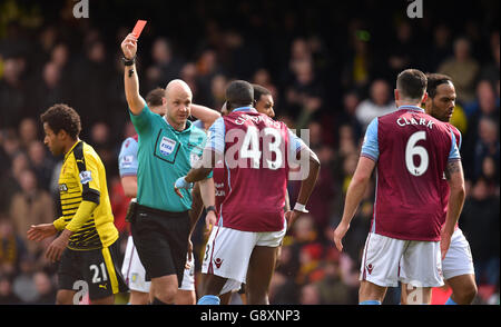 Aston Villa's Aly Cissokho (centre) is shown a red card by referee Anthony Taylor during the Barclays Premier League match at Vicarage Road, Watford. Stock Photo
