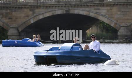 Visitors to Hyde Park ride paddle boats along the Serpentine, London, as it has finally felt like spring has arrived over the past week or so with much of the UK enjoying some fine and warm conditions. Stock Photo