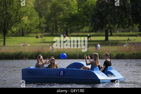 Visitors to Hyde Park ride paddle boats along the Serpentine, London, as it has finally felt like spring has arrived over the past week or so with much of the UK enjoying some fine and warm conditions. Stock Photo