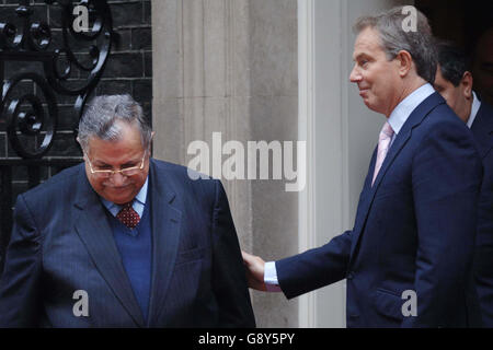 Britain's Prime Minister Tony Blair (R) with Iraqi president Jalal Talabani outside 10, Downing Street, central London, Thursday October 6, 2005. Blair met the Iraqi president to discuss preparations for the referendum on the new Iraqi constitution. The Iraqi leader is visiting London during his first official visit to Europe since taking office in April. The meeting comes a day after a senior British official blamed Iran's Revolutionary Guard for supplying the lethal explosive technology responsible for killing British soldiers in Iraq. The official said that there was evidence that the Stock Photo