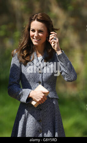 The Duchess of Cambridge views Hampton Court's recently unveiled Magic Garden, marking the official opening of the palace's new children's play area. Stock Photo