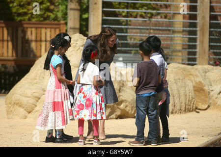 The Duchess of Cambridge meets children as she views Hampton Court's recently unveiled Magic Garden, marking the official opening of the palace's new children's play area. Stock Photo