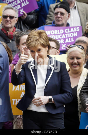 First Minister and SNP leader Nicola Sturgeon makes a thumbs-up gesture during an SNP campaign event on Buchanan Street in Glasgow on the eve of the Scottish Parliament election. Stock Photo