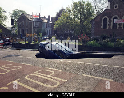 A car which has partially disappeared down a sinkhole in Woodland Terrace in Greenwich, south-east London.
