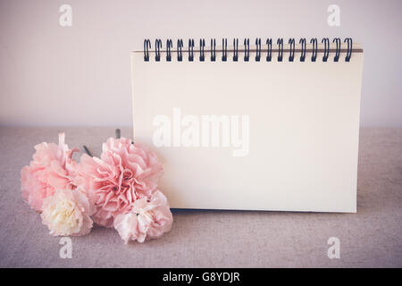 Notepad with pink flowers mock up, selective focus, toning Stock Photo