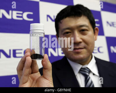 Thursday. 30th June, 2016. Tokyo, Japan. 30th June, 2016. Japanese electronics giant NEC's IoT Device Research Laboratory researcher Ryota Yuge displays the new nano carbon material 'carbon nanobrush' which is a fibrous aggregate of carbon nanohorns at the company's headquarters in Tokyo on Thursday, June 30, 2016. NEC said this discovery of the new nano carbon material was the world's first and which features well adsorptivity and electrical conductivity to improve the basic functionality of a range of devices such as batteries, capacitors and actuators. Credit:  Aflo Co. Ltd./Alamy Live News Stock Photo