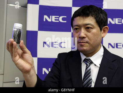 Thursday. 30th June, 2016. Tokyo, Japan. 30th June, 2016. Japanese electronics giant NEC's IoT Device Research Laboratory researcher Ryota Yuge displays the new nano carbon material 'carbon nanobrush' which is a fibrous aggregate of carbon nanohorns at the company's headquarters in Tokyo on Thursday, June 30, 2016. NEC said this discovery of the new nano carbon material was the world's first and which features well adsorptivity and electrical conductivity to improve the basic functionality of a range of devices such as batteries, capacitors and actuators. Credit:  Aflo Co. Ltd./Alamy Live News Stock Photo