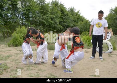 Bayan Nur, China's Inner Mongolia Autonomous Region. 30th June, 2016. Kids practice wrestling at a kindergarten of Urad Middle Banner in Bayan Nur City, north China's Inner Mongolia Autonomous Region, June 30, 2016. Courses of Matouqin, wrestling, archery and Mongolian dancing were set up in kindergartens and primary schools of Urad Middle Banner. © Zhi Maosheng/Xinhua/Alamy Live News Stock Photo