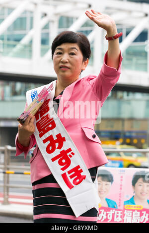 Mizuho Fukushima, Member of the House of Councillors and Social Democratic Party candidate for next House of Councillors elections, campaigns outside Shinjuku Station on July 1, 2016, Tokyo, Japan. Fukushima and the Social Democratic Party, along with the with the Democratic Party and the Japanese Communist Party, are calling on the public to participate in the next House of Councillors elections to try to stop the Liberal Democratic Party of Prime Minister Shinzo Abe from returning a majority. This is the first time that young voters (18 and 19 year-olds) will be allowed to take part in the e Stock Photo