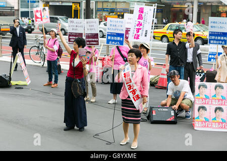 Mizuho Fukushima, Member of the House of Councillors and Social Democratic Party candidate for next House of Councillors elections, campaigns outside Shinjuku Station on July 1, 2016, Tokyo, Japan. Fukushima and the Social Democratic Party, along with the with the Democratic Party and the Japanese Communist Party, are calling on the public to participate in the next House of Councillors elections to try to stop the Liberal Democratic Party of Prime Minister Shinzo Abe from returning a majority. This is the first time that young voters (18 and 19 year-olds) will be allowed to take part in the e Stock Photo