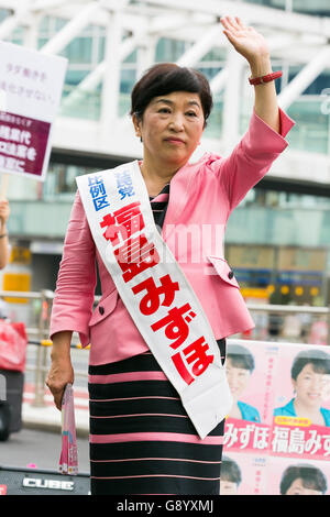 Mizuho Fukushima, Member of the House of Councillors and Social Democratic Party candidate for next House of Councillors elections, campaigns outside Shinjuku Station on July 1, 2016, Tokyo, Japan. Fukushima and the Social Democratic Party, along with the with the Democratic Party and the Japanese Communist Party, are calling on the public to participate in the next House of Councillors elections to try to stop the Liberal Democratic Party of Prime Minister Shinzo Abe from returning a majority. This is the first time that young voters (18 and 19 year-olds) will be allowed to take part in the e Stock Photo