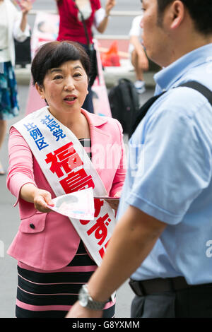 Mizuho Fukushima, Member of the House of Councillors and Social Democratic Party candidate for next House of Councillors elections, campaigns outside Shinjuku Station on July 1, 2016, Tokyo, Japan. Fukushima and the Social Democratic Party, along with the with the Democratic Party and the Japanese Communist Party, are calling on the public to participate in the next House of Councillors elections to try to stop the Liberal Democratic Party of Prime Minister Shinzo Abe from returning a majority. This is the first time that young voters (18 and 19 year-olds) will be allowed to take part in the e Stock Photo