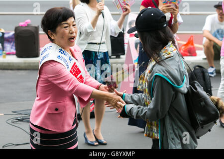 Mizuho Fukushima, Member of the House of Councillors and Social Democratic Party candidate for next House of Councillors elections, campaigns outside Shinjuku Station on July 1, 2016, Tokyo, Japan. Fukushima and the Social Democratic Party, along with the with the Democratic Party and the Japanese Communist Party, are calling on the public to participate in the next House of Councillors elections to try to stop the Liberal Democratic Party of Prime Minister Shinzo Abe from returning a majority. This is the first time that young voters (18 and 19 year-olds) will be allowed to take part in the e Stock Photo