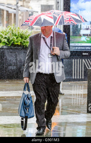 Manchester, UK. 1st July, 2016. UK Weather:  Torrential heavy downpours of rain soak shoppers in Manchester City Centre.  The unsettled weather across the north west of England caught shoppers by surprise with heavy outbursts of rain this afternoon.  Some were prepared but others use alternative techniques to shelter.  Credit:  Cernan Elias/Alamy Live News Stock Photo