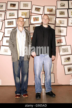 Artists Jake (right) and Dinos Chapman pose in front of their work 'Disasters of War IV' (2001), during a press preview of their new exhibition 'Like a dog returns to its vomit' - which runs from 19 October to 3 December - at the White Cube gallery in Hoxton Square, east London, Tuesday 18 October 2005, PRESS ASSOCIATION Photo. Photo credit should read: Yui Mok/PA Stock Photo
