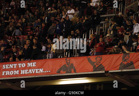 Soccer - Carling Cup - Third Round - Manchester United v Barnet - Old Trafford. A banner with Manchester United's legends Bobby Charlton, Brian Law and George Best adorn the Stretford End stand Stock Photo
