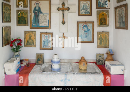 interior of Greek roadside shrine near Loggos, Paxos, Greece - the small shrines are usually to commemorate those who have died Stock Photo