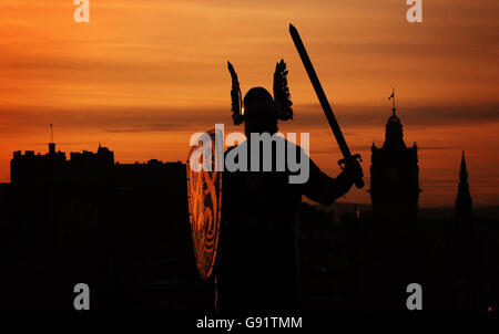 Viking Peter Fraser silhouetted against the sunset in Edinburgh, Scotland. Peter, a member of the Lerwick Up Helly Aa Vikings, arrived in Edinburgh to promote the Torchlight Procession, where 15,000 people holding torches follow a Viking long boat through the streets of the capital. Stock Photo