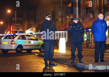 Armed police officers in Morley Street, Bradford, where a woman police officer was shot dead Friday November 18, 2005. The female police officer was shot dead and a second injured while responding to a robbery at a city centre shop today. The women officers had been called to a robbery at a shop in Morley Street, in Bradford city centre, at around 3.25pm, West Yorkshire police said. See PA story POLICE Officer. PRESS ASSOCIATION Photo. Photo credit should read: John Giles/PA. Stock Photo