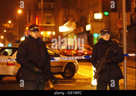 Armed police officers in Morley Street, Bradford, where a woman police officer was shot dead Friday November 18, 2005. The female police officer was shot dead and a second injured while responding to a robbery at a city centre shop today. The women officers had been called to a robbery at a shop in Morley Street, in Bradford city centre, at around 3.25pm, West Yorkshire police said. See PA story POLICE Officer. PRESS ASSOCIATION Photo. Photo credit should read: John Giles/PA. Stock Photo