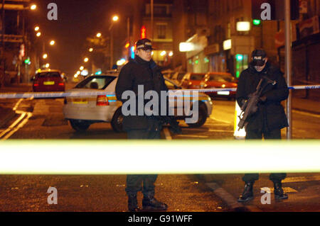 Armed police officers in Morley Street, Bradford, where a woman police officer was shot dead Friday November 18, 2005. The female police officer was shot dead and a second injured while responding to a robbery at a city centre shop today. The women officers had been called to a robbery at a shop in Morley Street, in Bradford city centre, at around 3.25pm, West Yorkshire police said. See PA story POLICE Officer. PRESS ASSOCIATION Photo. Photo credit should read: John Giles/PA. Stock Photo