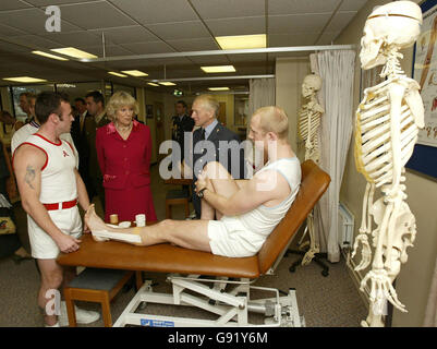 Britain's Duchess of Cornwall talks to Sergeant Ian Mugglestone (R), as Group Captain David Jones, the Director of Defence Rehabilitation (2R), and Corporal Steve Sharpe (L) look-on during a visit to the Defence Medical Rehabilitation Centre in Epsom Thursday November 24, 2005, with her husband, the Prince of Wales. See PA story ROYAL Wounded. PRESS ASSOCIATION Photo. Photo credit should read: Paul Hackett / RTRS/ WPA Rota / PA. Stock Photo