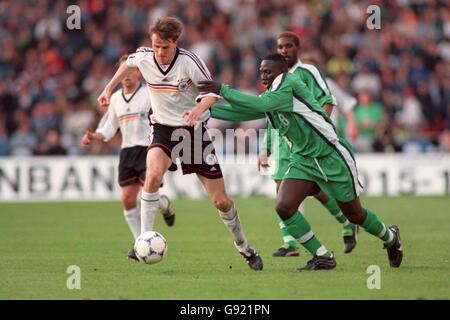 Soccer - Friendly - Germany v Nigeria. Nigeria's Pascal Patrick (R) tries to tackle Germany's Dietmar Hamann (L) Stock Photo
