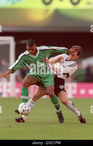 Nigeria's Sunday Oliseh (L) hands off Germany's Andreas Moller (R) Stock Photo