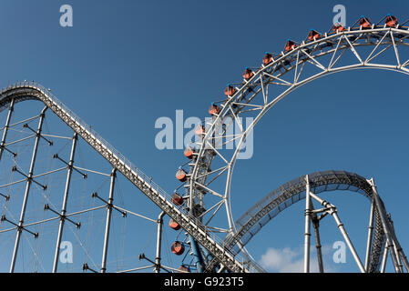 Roller coaster and Ferris wheel, Tokyo Dome City Attractions amusement park, Japan Stock Photo