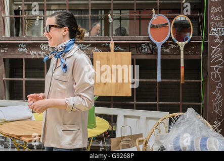 Madrid, Spain, 12 st June 2016.  An antiques store view with a woman in DecorAccion Market, Letters Quarter, Madrid, Spain. Stock Photo