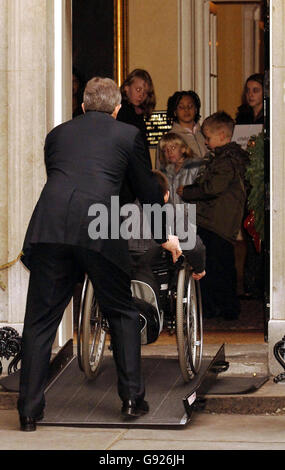 Britain's Prime Minister Tony Blair helps push wheelchair bound Michael Taylor , 17, from Crewe, when he and several other children handed a letter to the Mr Blair calling for action against child poverty, Wednesday December 21, 2005. Members of the Child Poverty Action Group (CPAG) met Tony Blair on the steps of Number 10 exactly 40 years after the group first urged Harold Wilson to take action to improve standards of living for the poorest families. See PA Story POLITICS Poverty. PRESS ASSOCIATION Photo. Photo credit should read: John Stillwell/PA Stock Photo