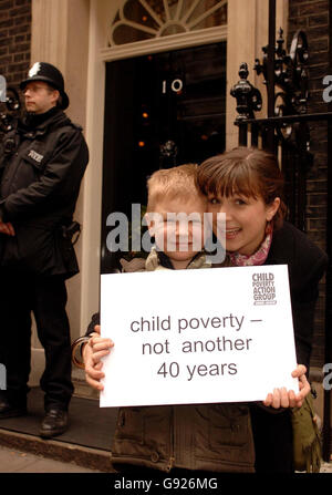 Caleb Calikes, 6, with his mother Janine, outside the door of 10 Downing Street, when he and several other children handed a letter to the Britain's Prime Minister Tony Blair calling for action against child poverty, Wedenesday December 21, 2005. Members of the Child Poverty Action Group (CPAG) met Tony Blair on the steps of Number 10 exactly 40 years after the group first urged Harold Wilson to take action to improve standards of living for the poorest families. See PA Story POLITICS Poverty. PRESS ASSOCIATION Photo. Photo credit should read: John Stillwell/PA Stock Photo