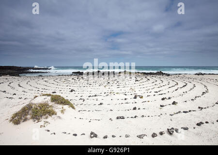 White sandy beach and rock sculpture near Orzola Northern Lanzarote, Canary Islands Stock Photo