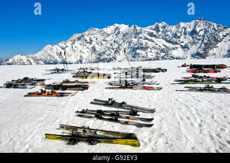 Pairs of skis lying in the snow at Col du Joly during a break, skiing area Les Contamines-Montjoie, Haute-Savoie, France Stock Photo