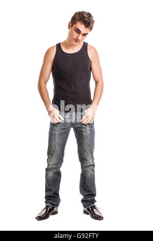 cute young man in jeans and t-shirt looking at the camera, against white background Stock Photo