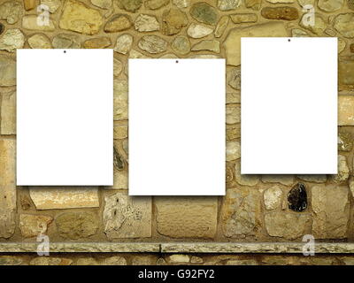 Close-up of three nailed blank frames on brown stone wall background Stock Photo