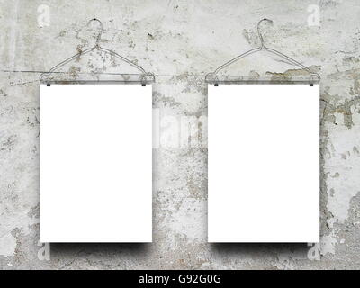 Close-up of two square blank frames hanged by clothes hanger against gray weathered concrete wall background Stock Photo