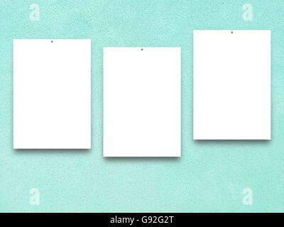 Close-up of three nailed blank frames on aqua rough plaster wall background Stock Photo