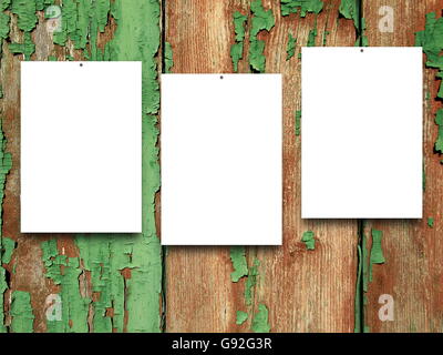 Close-up of three nailed blank frames on green and brown scratched wooden boards background Stock Photo