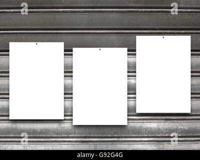 Close-up of three nailed blank frames on gray rusty metal shutter background Stock Photo