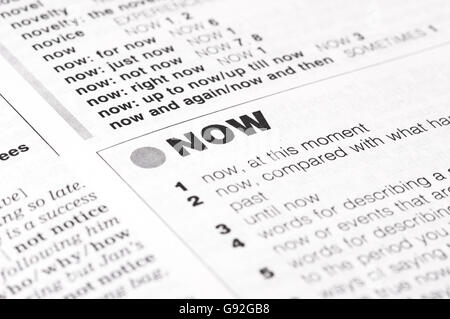 An Open Page of A Dictionary on Now Definition Stock Photo