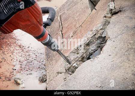 Construction tool, the jackhammer with demolition debris Stock Photo