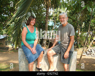 Asian tsunami survivors Rosie and Brian Lowe in Mirissa, Sri Lanka, Sunday December 25, 2005. The Britiish couple who cheated death when the tsunami crashed into a small Sri Lankan village have returned to thank the locals who helped save their lives. Brian and Rosie Lowe were on holiday on the south coast of the island when the tsunami struck. In an extraordinary turn of events, not only did they manage to survive the tidal waves which crushed their hotel, they with the help of a local politician and the kind-heartedness of the Sri Lankan people, escaped the carnage of the aftermath and Stock Photo