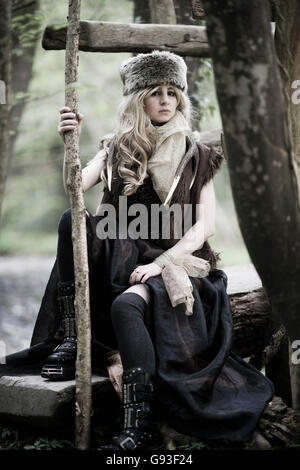 A young woman modeling for a Fantasy makeover 'game of thrones' style outdoors photography : Goddess / Priestess / Huntress in the forest., UK Stock Photo