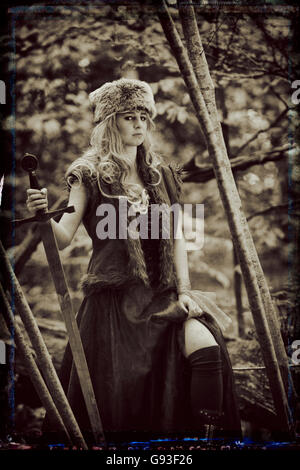 A young woman modeling for a Fantasy makeover 'game of thrones' style outdoors photography : Goddess / Priestess / Huntress in the forest., UK Stock Photo