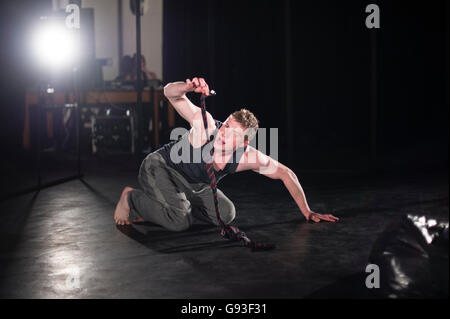 A young male student at Aberystwyth University theatre studies department performing a self-devised one-man solo intensive physical theatre production project as part of his final year degree assessment  Wales UK Stock Photo